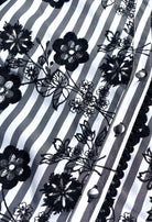 Fee G Ria floral flock stripe fabric close-up showing black embroidery and lace edge