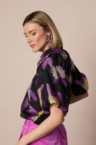 Side view of Fee G Dee purple floral print blouse