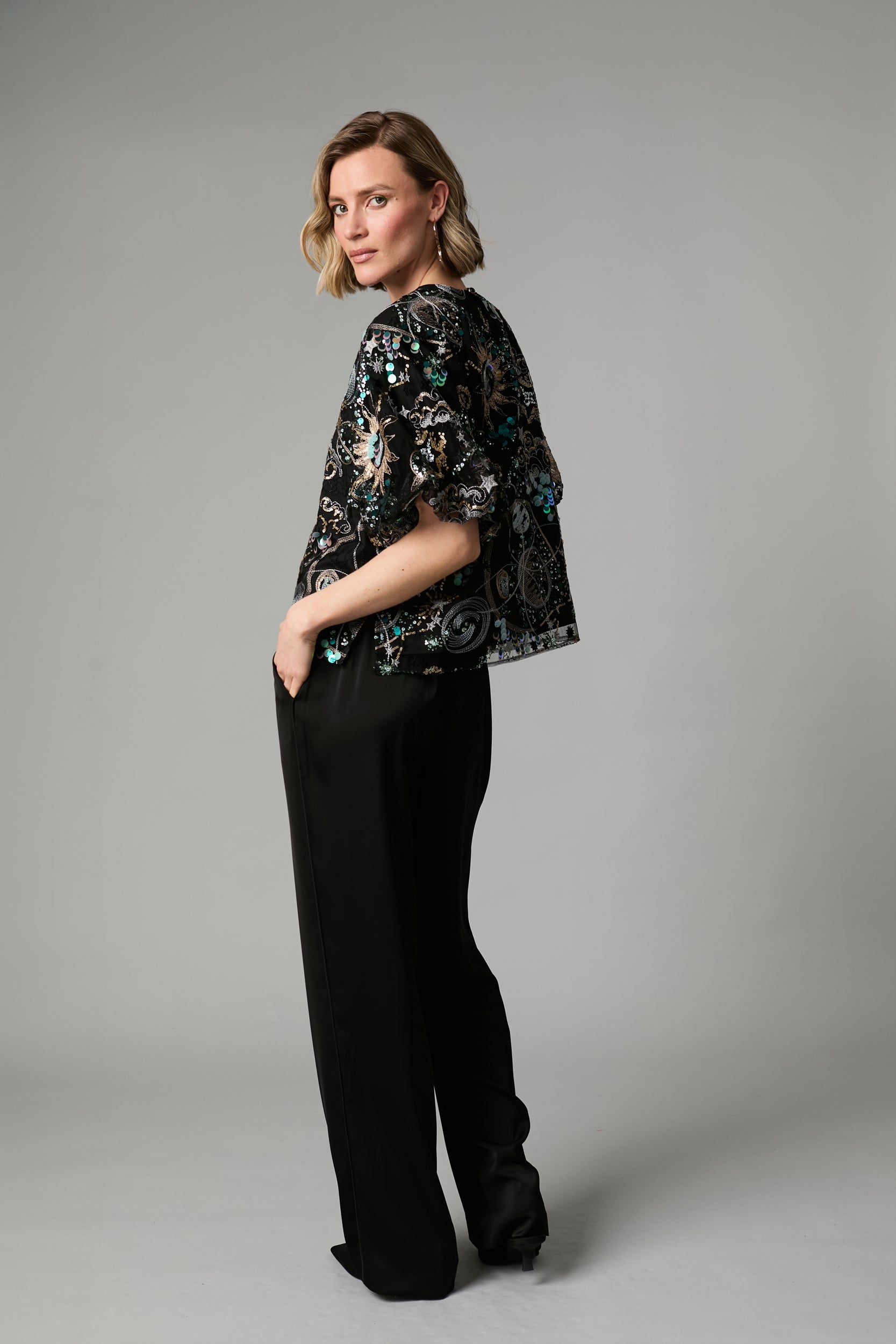 Fee G Stellar black embroidered sequin top side view showing voluminous sleeves