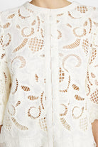 Close-up of embroidered lace and scalloped detail on Gustav white shirt