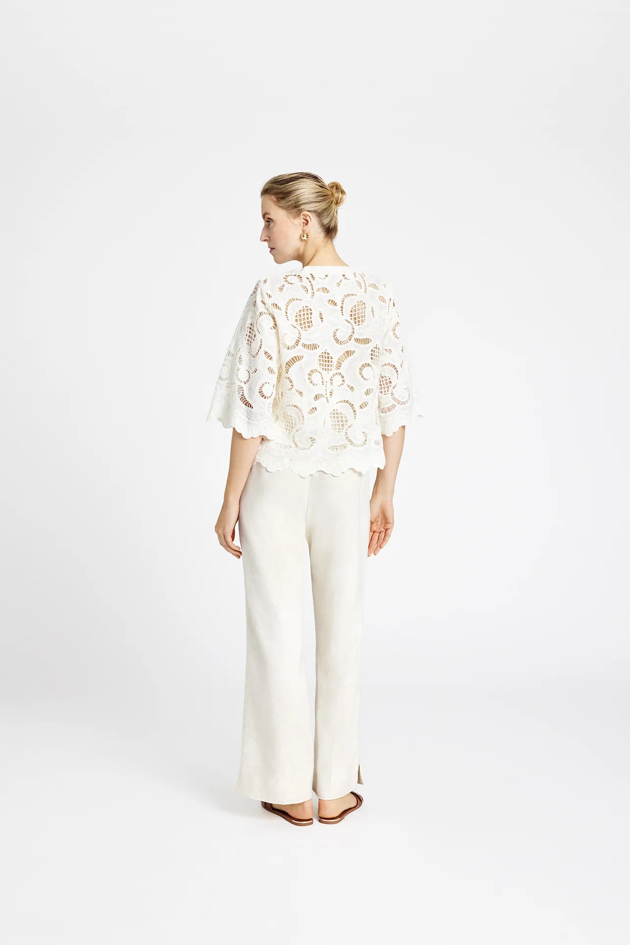 Back view of Gustav embroidered white cotton shirt with scalloped hem