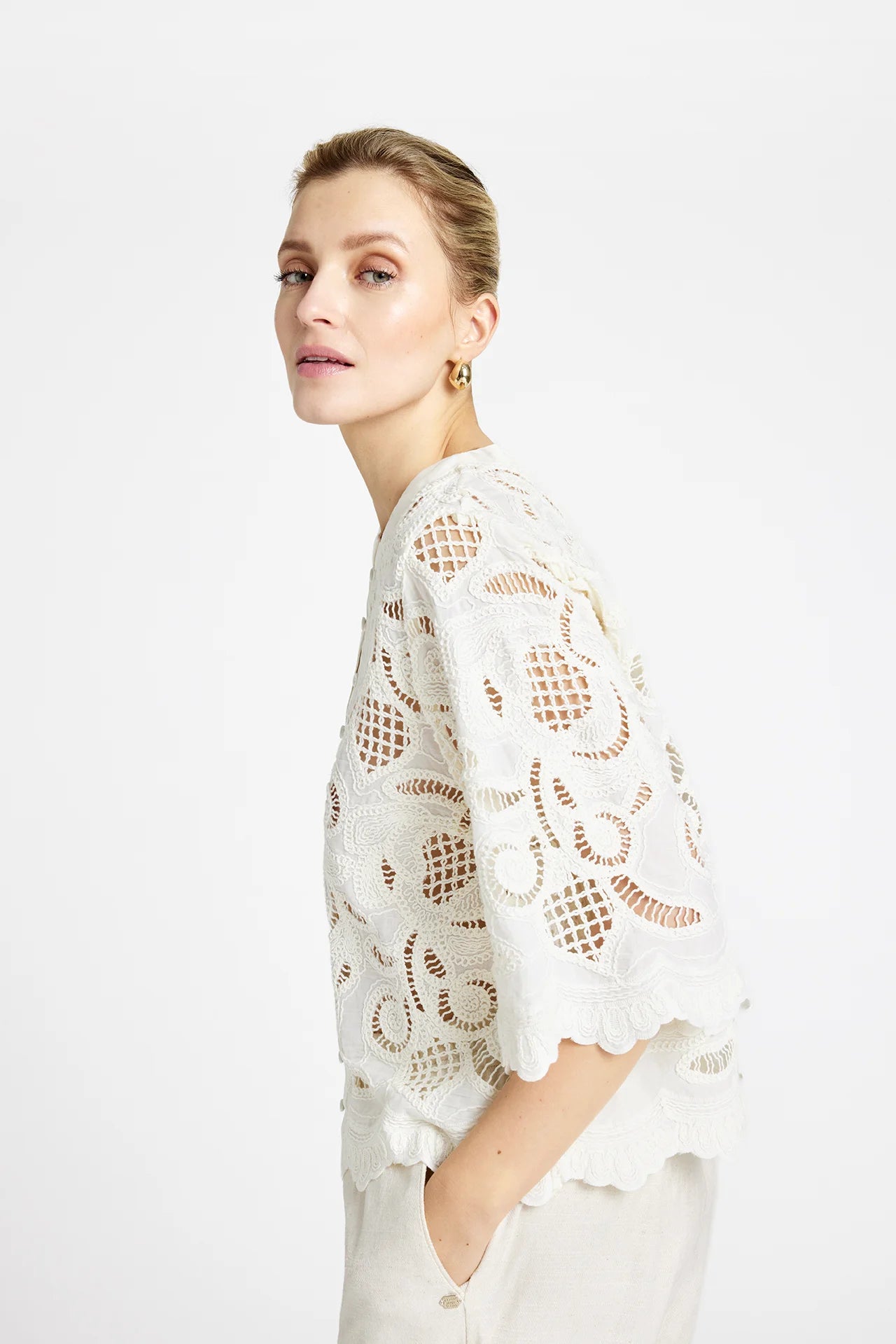 Side view of Gustav Grazia white lace shirt styled for summer