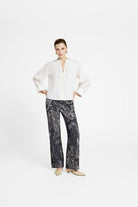 Gustav Kaisa cream lyocell blouse on model — V-neck with scalloped frill placket and cuffed sleeves