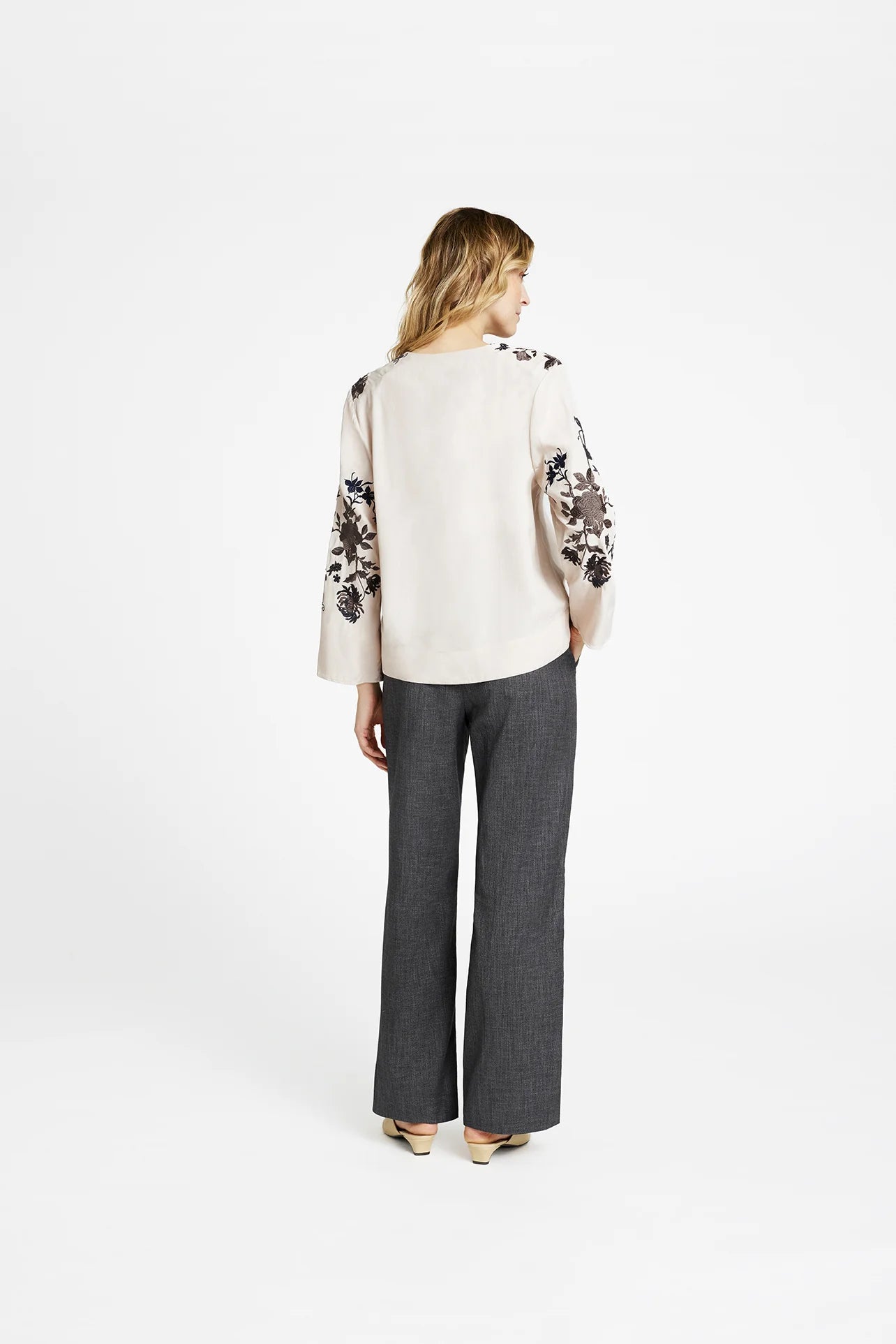 Back view of Gustav Naja loose fit blouse with embroidered sleeve accents