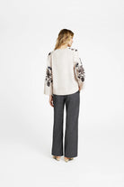 Back view of Gustav Naja loose fit blouse with embroidered sleeve accents