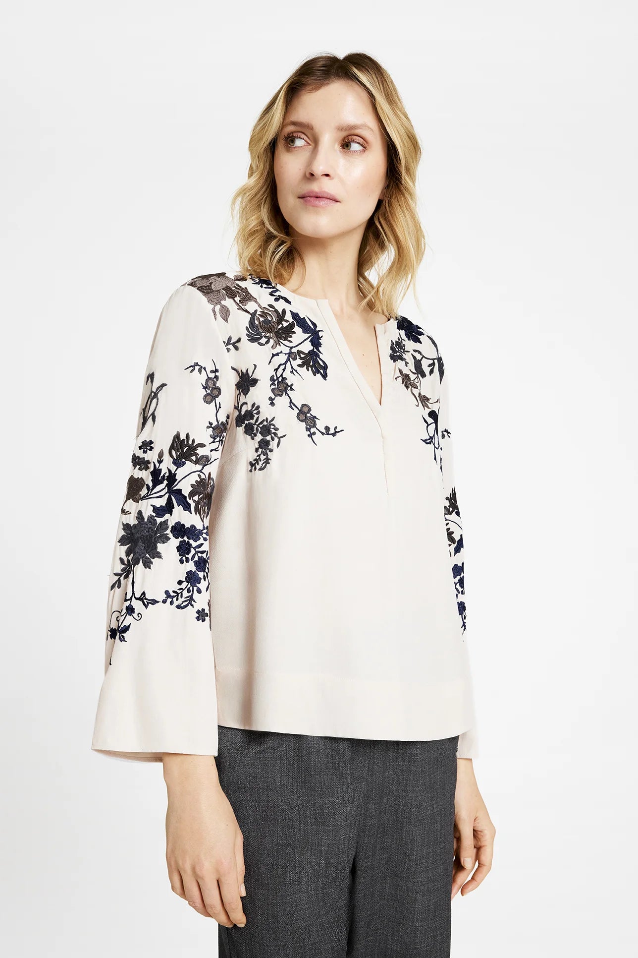 Close-up side view of Gustav Naja blouse showing embroidered wide sleeve detail.