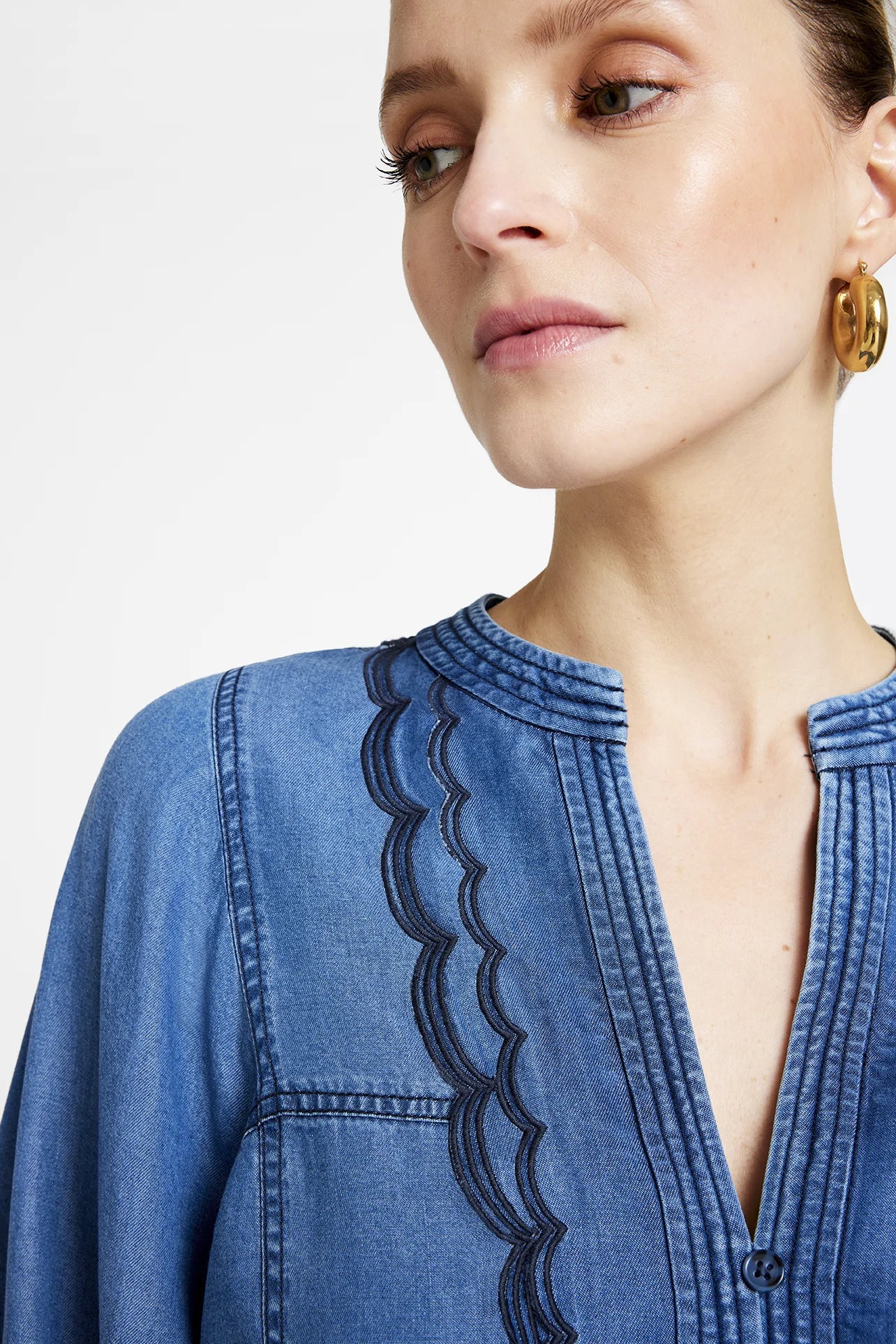 Close-up of frilled collar and cuff detail on Gustav Kaisa denim shirt