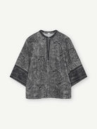 The Gustav Neomi blouse brings a black and sand paisley print to a relaxed silhouette with wide three-quarter sleeves. A contrast border frames the neckline and returns at the cuffs, breaking up the all-over pattern. Wear it with the matching Gustav Babbett paisley trousers for the full co-ord. For daytime, pair it with black denim to keep the focus on the print.