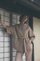 Gustav Dua camel wool blend jacket styled with matching belt and relaxed cape sleeves.