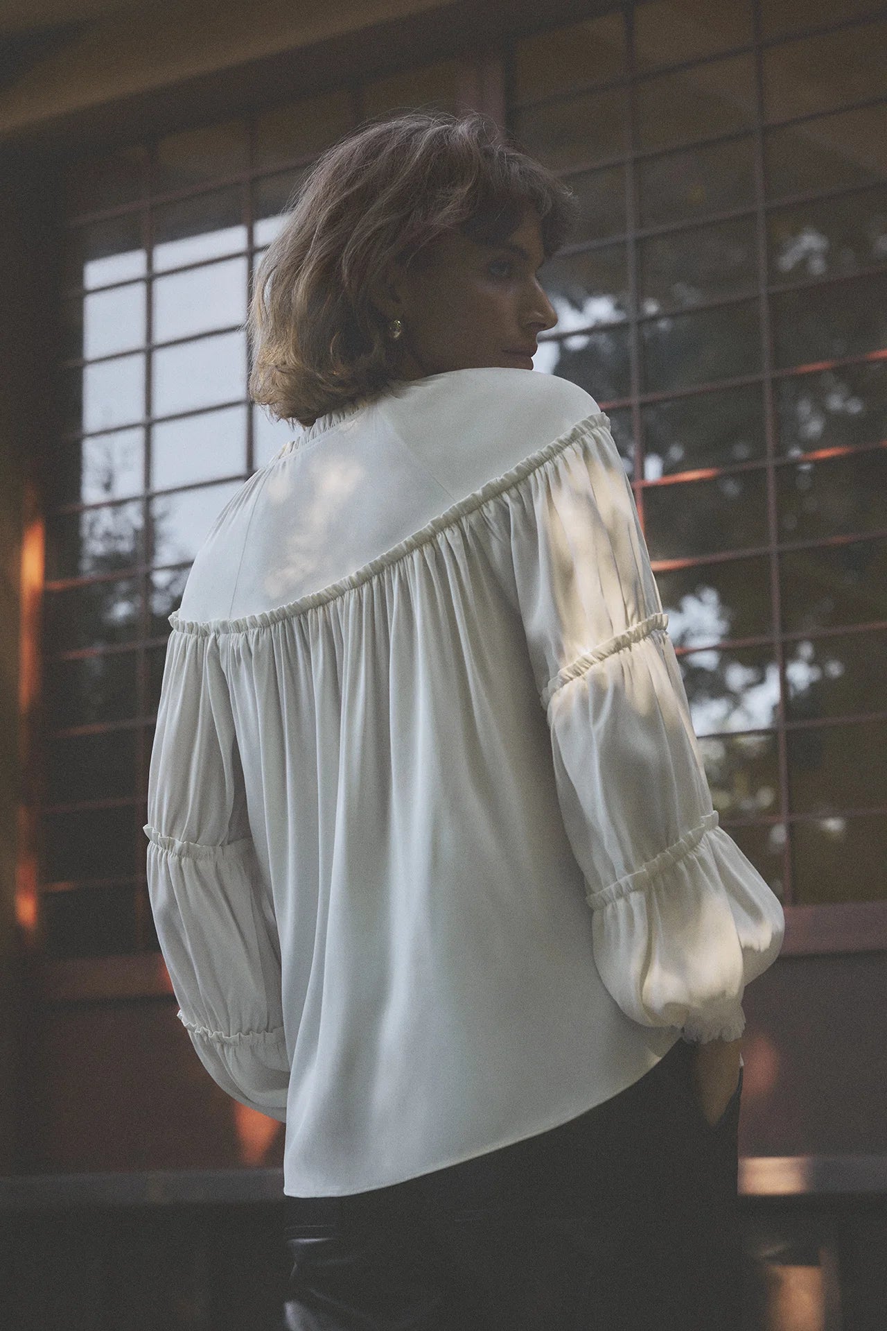 Back view of Gustav Annsofie off-white blouse showing gathered pleats and softly voluminous sleeves.