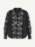 Gustav Bayanna black blouse with intricate ivory floral embroidery, classic collar and long sleeves – front view.