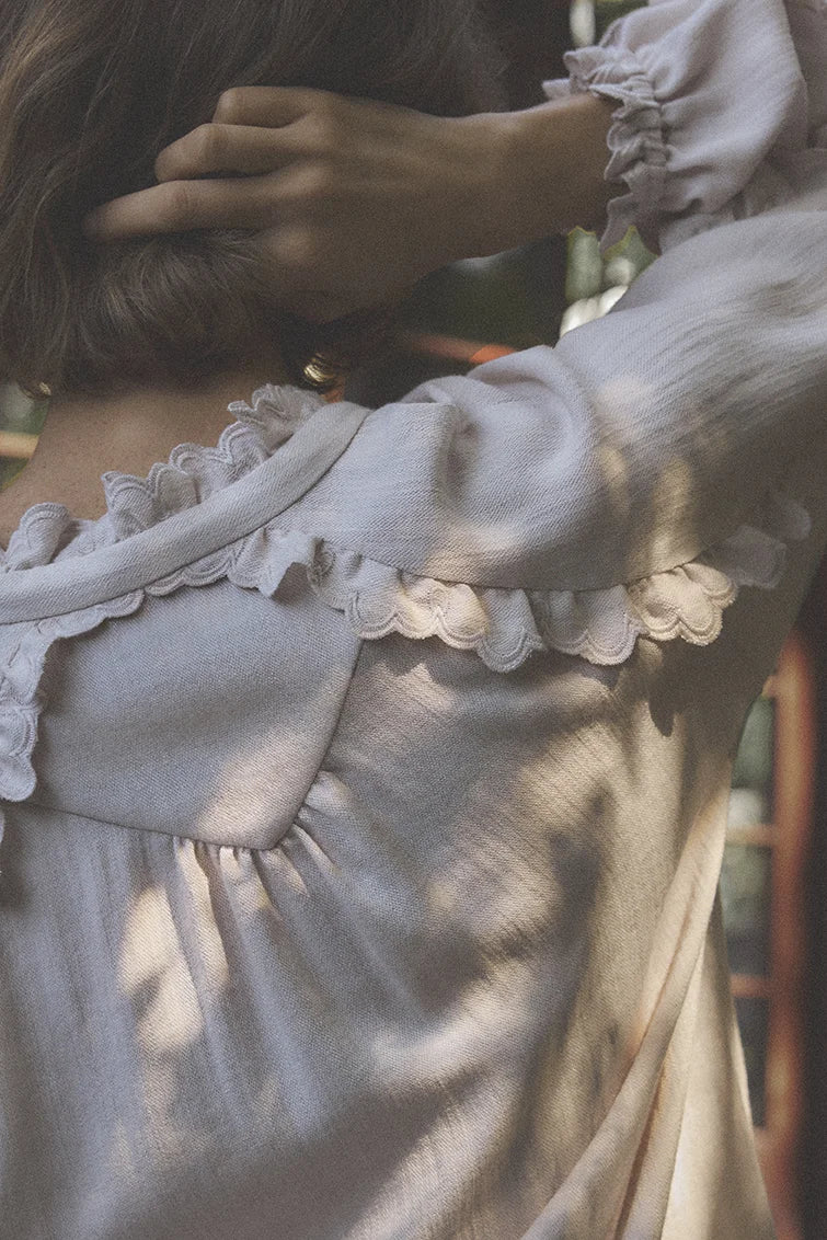 Close-up of Gustav Annsofie almond blouse showing delicate shoulder ruffles and gathered detailing
