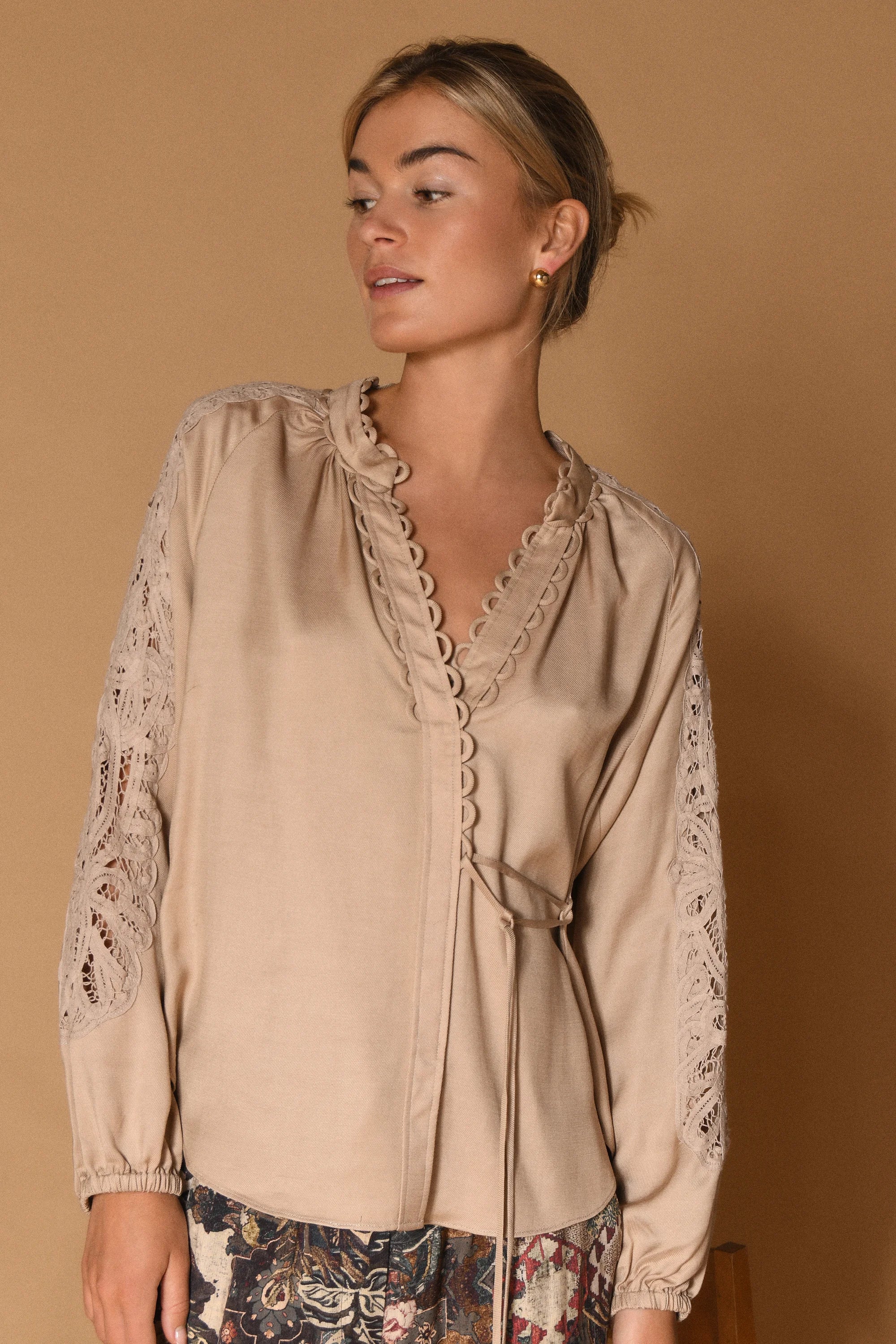 Gustav Phia Sand Stone blouse – model view showing lace sleeves and side tie