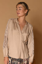Gustav Phia Sand Stone blouse – model view showing lace sleeves and side tie