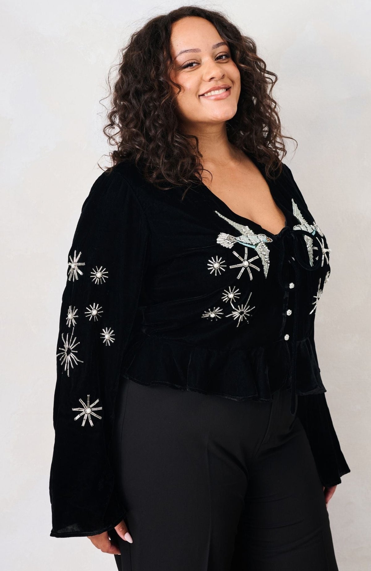 Hope & Ivy Glacia black velvet embellished party top – three-quarter curve model view