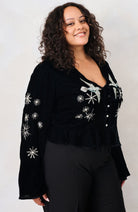 Hope & Ivy Glacia black velvet embellished party top – three-quarter curve model view