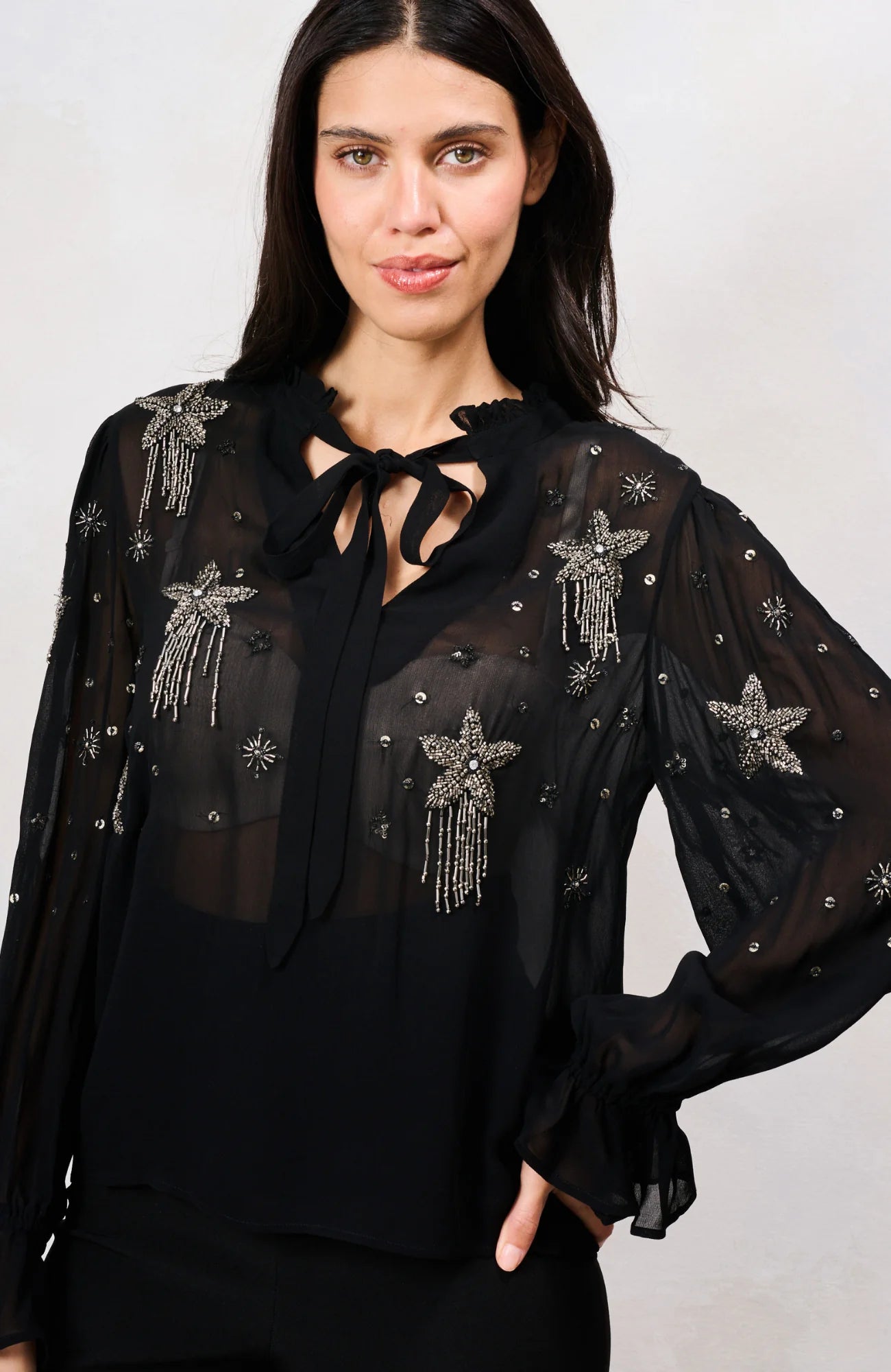 Hope & Ivy Elaris black embellished mesh top with beaded stars – front model close-up