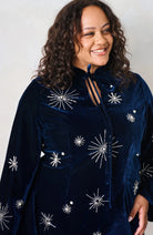 Close-up of Hope & Ivy Orelia embellished velvet dress showing tie neckline and silver star detailing.