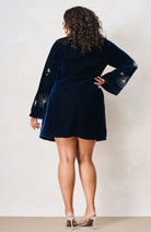 Hope & Ivy Orelia navy embellished velvet mini dress, full-length model view with hand on hip.