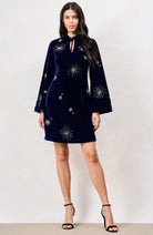 Hope & Ivy Orelia navy velvet mini dress with silver starburst embellishments and long flared sleeves, front view.