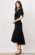 Hope & Ivy Sutton black midi dress with fitted waist and flared hem – side model view