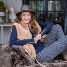 HV Society Yany navy roll neck jumper styled with patterned trousers and faux fur gilet