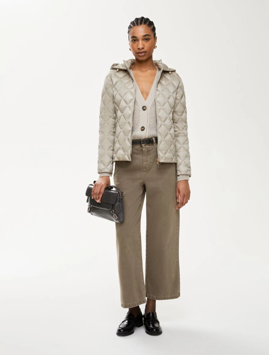 Model in iBlues Absence padded women’s jacket styled with wide-leg trousers