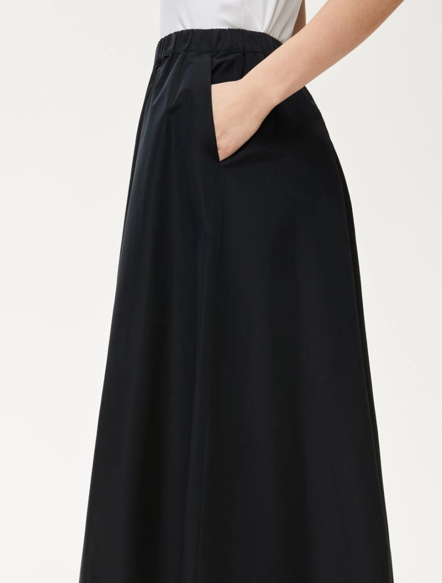Side view of black A-line Cavallo skirt with subtle volume and pockets