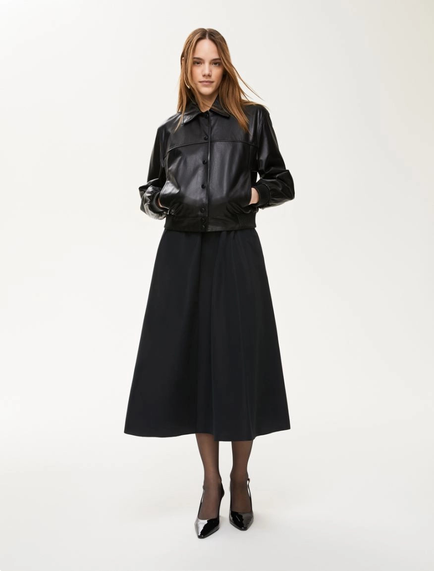 Model wearing black iBlues Cavallo A-line midi skirt with leather jacket