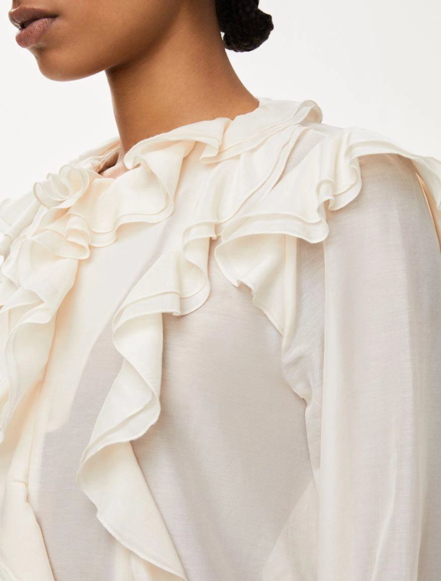 Side view of iblues ivory blouse with flowing frills and keyhole neckline
