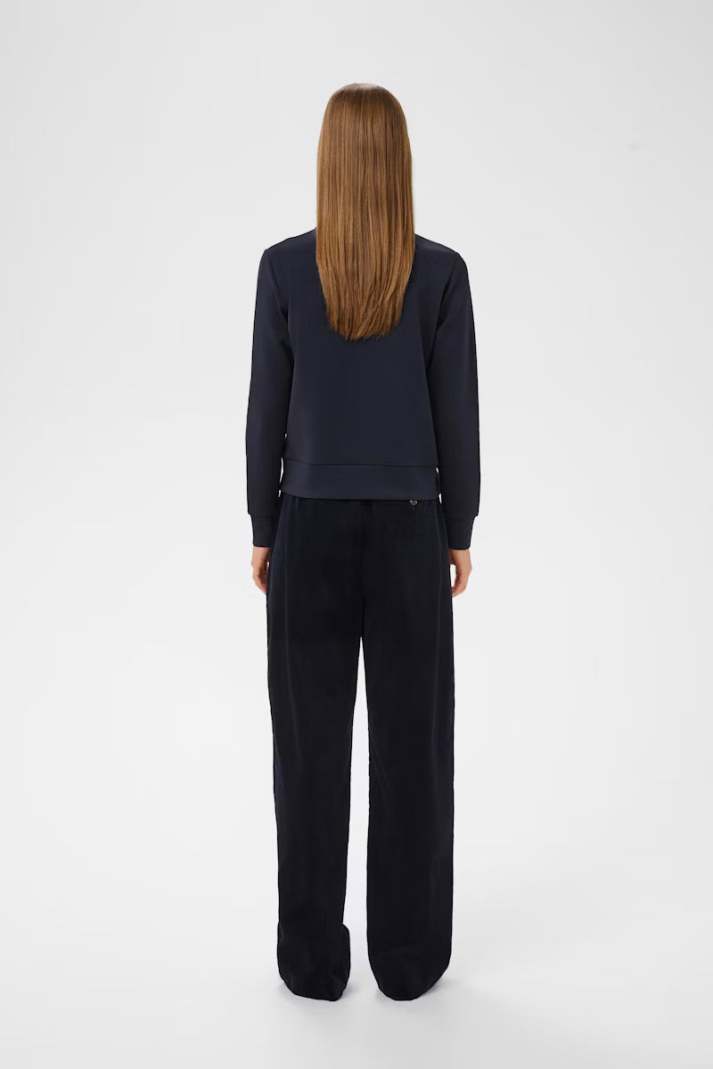 Studio shot of model wearing InWear BecaI jacket facing back In navy