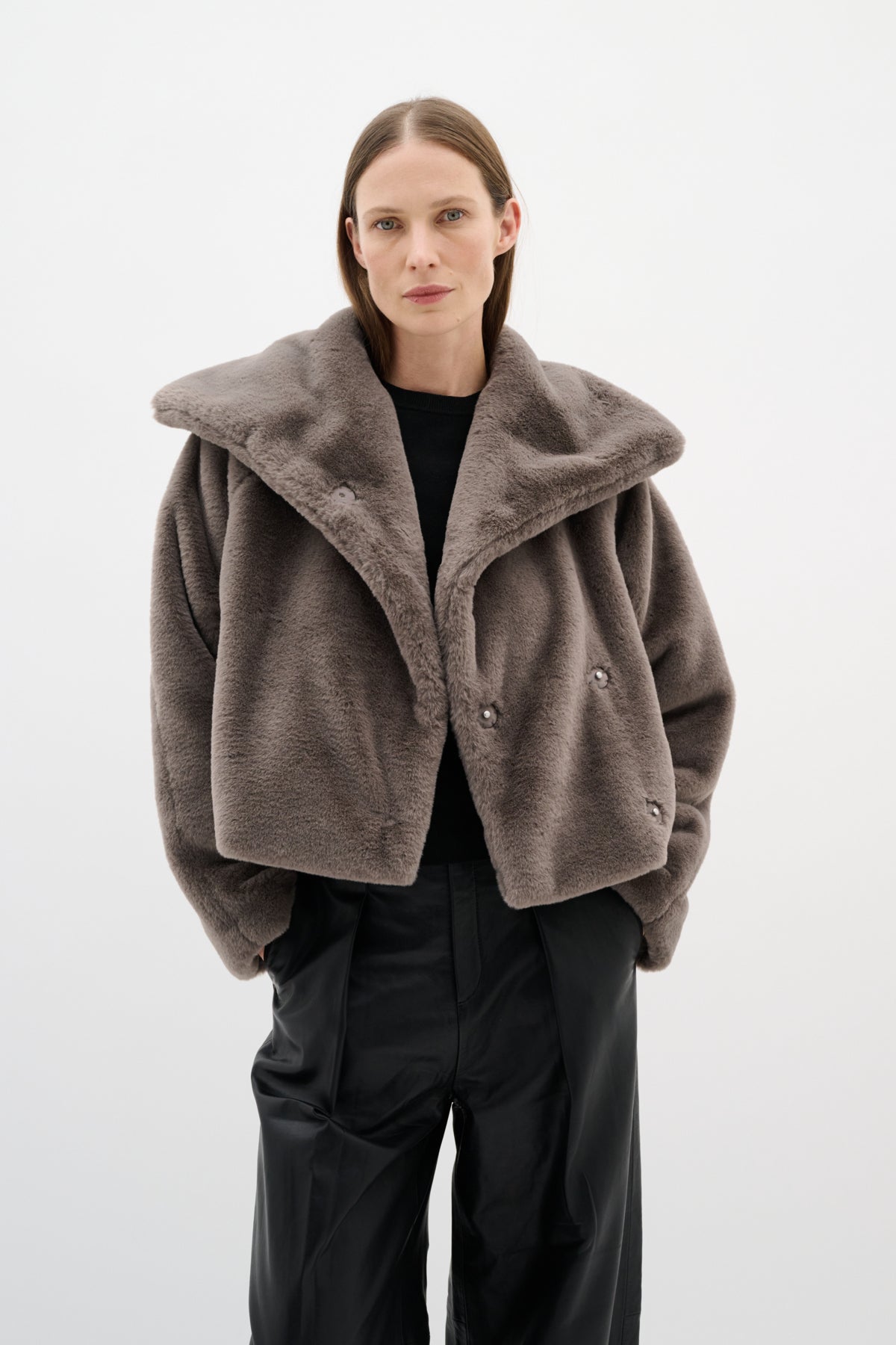 Cropped grey faux fur jacket with oversized collar styled with wide-leg trousers