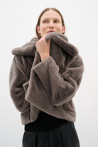 Overhead angle of model wearing InWear grey faux fur jacket with draped collar