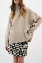 Model styling InWear BryaI tweed mini skirt with beige knit jumper