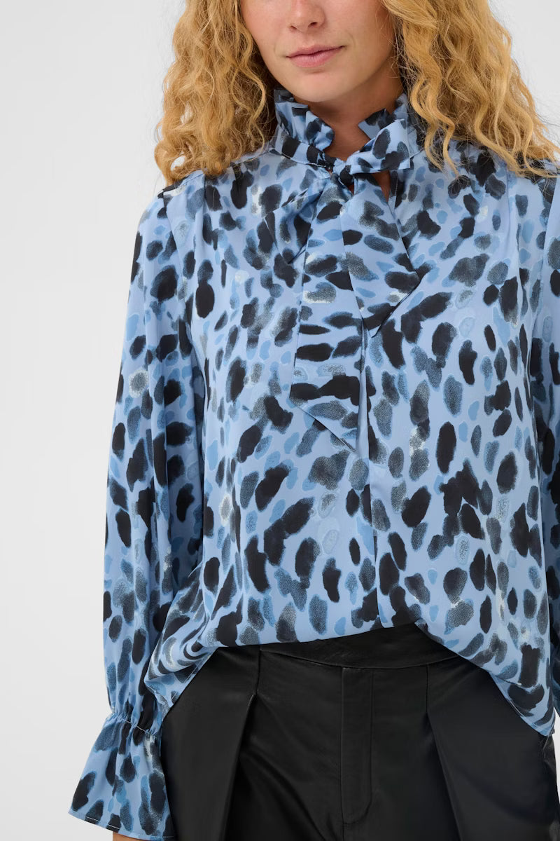 .	Close-up of InWear Gracie blouse with painterly spot print and tie neckline