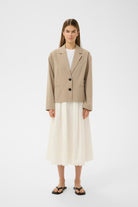 InWear cream midi skirt styled with beige blazer front view