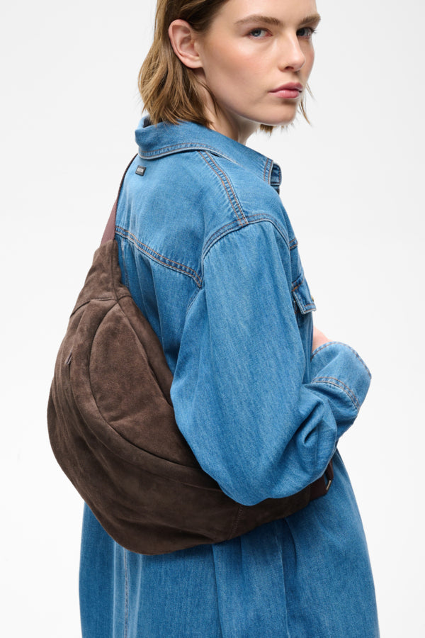 InWear Rasida chocolate brown suede sling bag side view on model