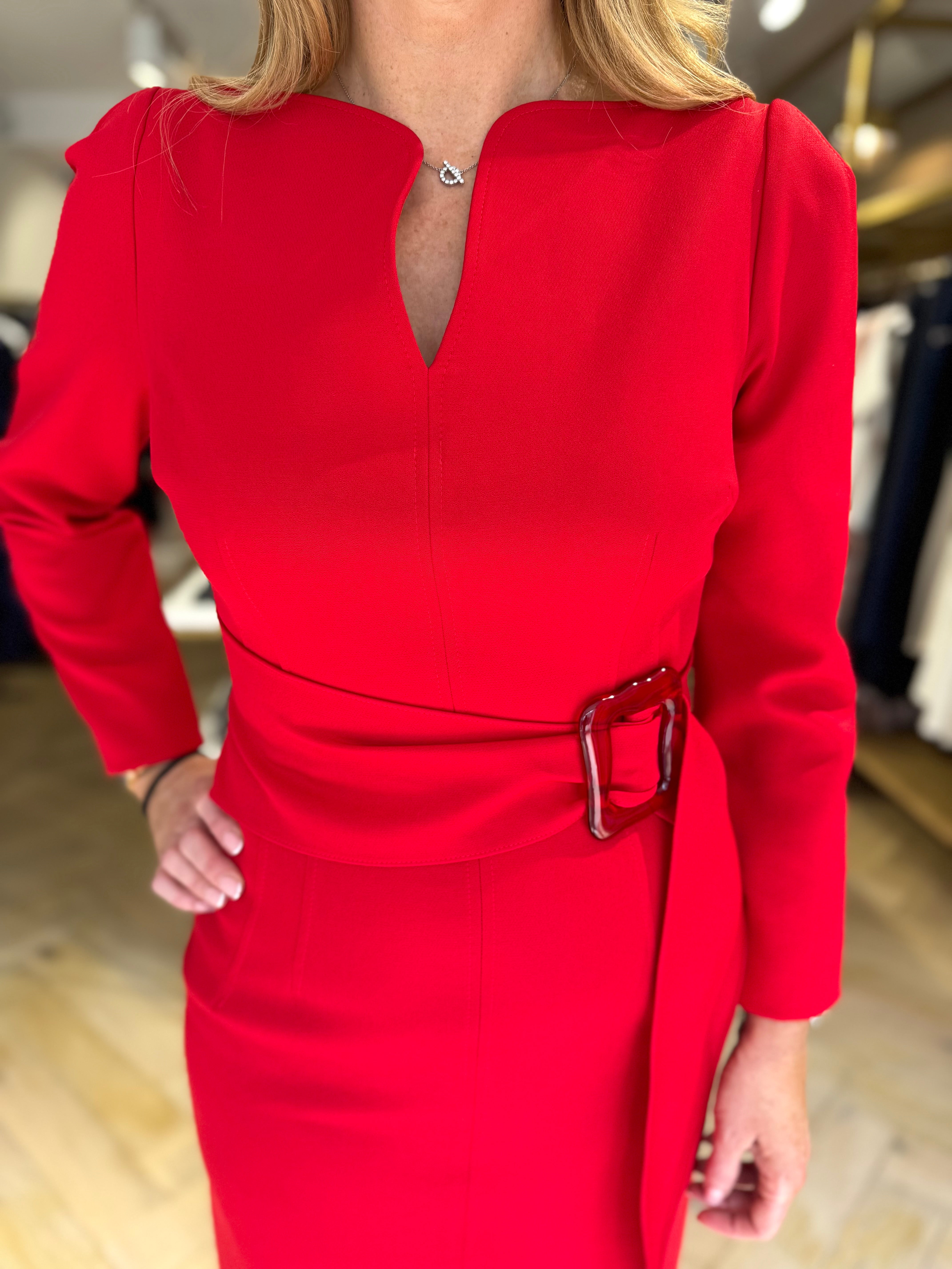 Boutique fitting of Kameya red belted dress with long sleeves and structured waist