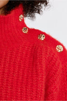 Lili Sidonio red fluffy jumper gold-tone shoulder button detail close-up