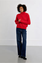 Lili Sidonio red fluffy button detail jumper styled with jeans