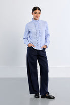 Lili Sidonio blue striped cotton shirt styled with navy trousers – full model view