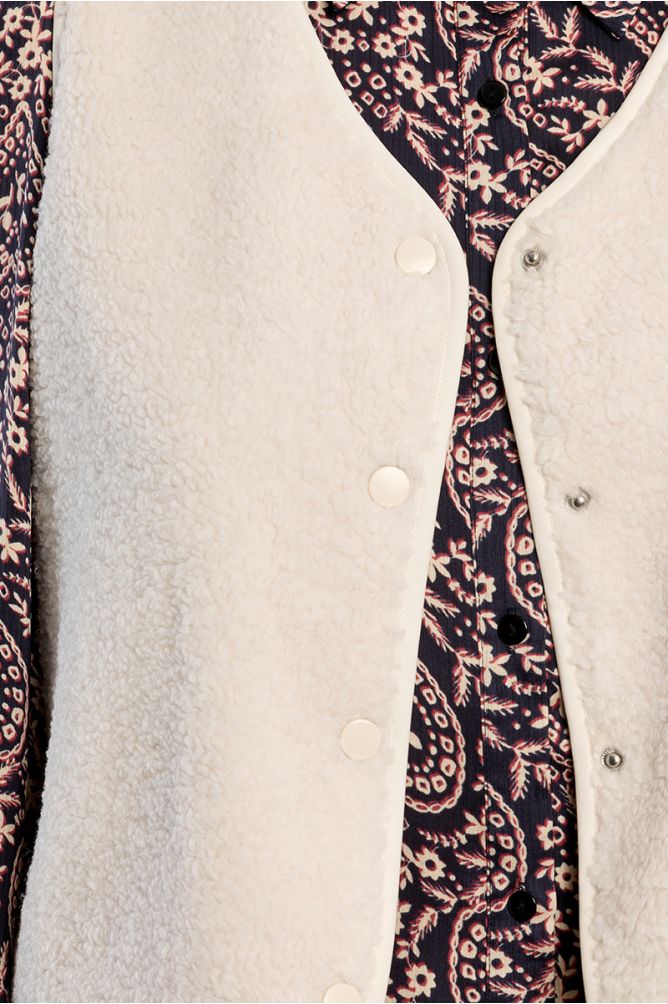 Lili Sidonio cream faux sheepskin vest snap button detail close-up