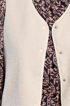 Lili Sidonio cream faux sheepskin vest snap button detail close-up