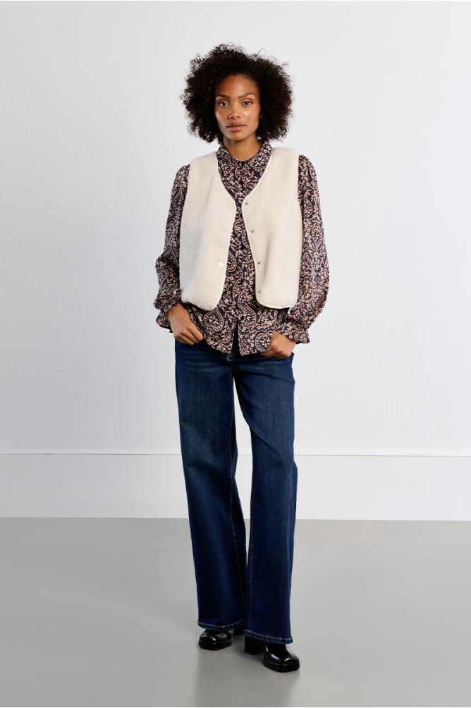 Lili Sidonio women’s cream sleeveless vest styled over printed blouse