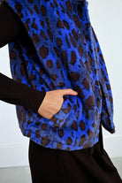 Close-up of Lili Sidonio gilet in blue leopard faux fur showing pockets 