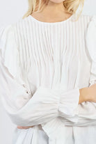 Lilli Sidinio Victorian-inspired white blouse with soft pleats and ruffle trim