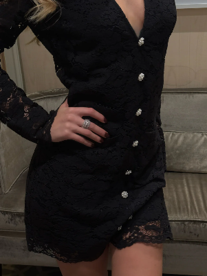 Model wearing Love Lolina black lace dress with deep V and button detail From back 