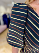 Side view of structured striped sleeve on Matilde Cano occasion dress