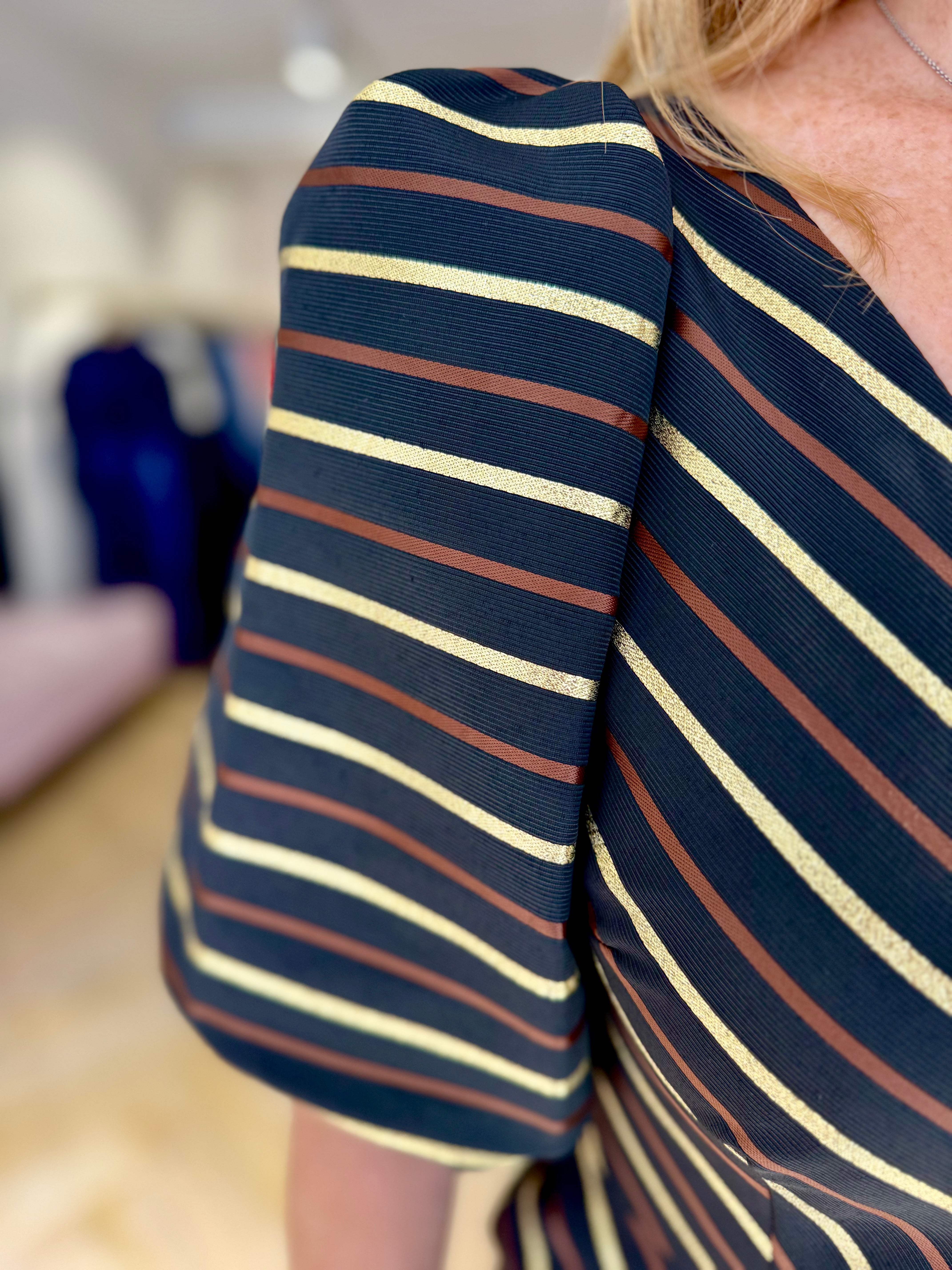 Side view of structured striped sleeve on Matilde Cano occasion dress