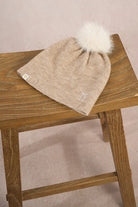 Molly Bracken women’s beige knit beanie with fluffy pom pom and stitched bow